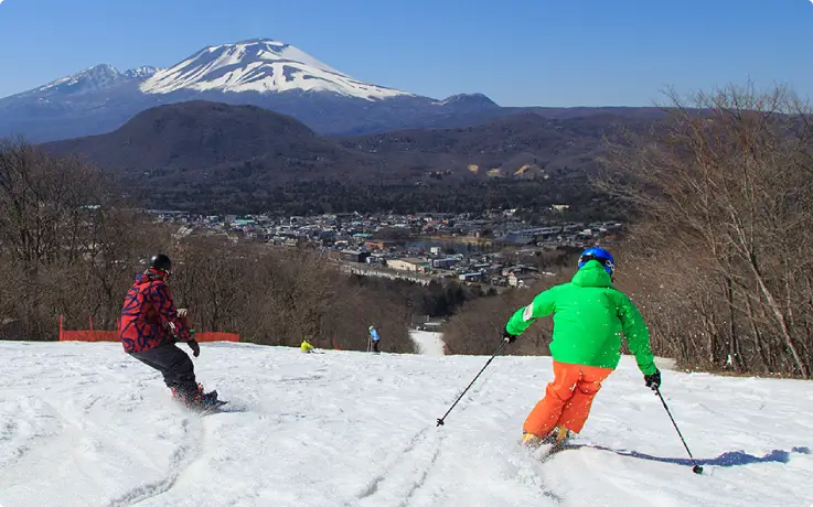 Skiers on snowy slopes at Karuizawa Prince Hotel Ski Resort.